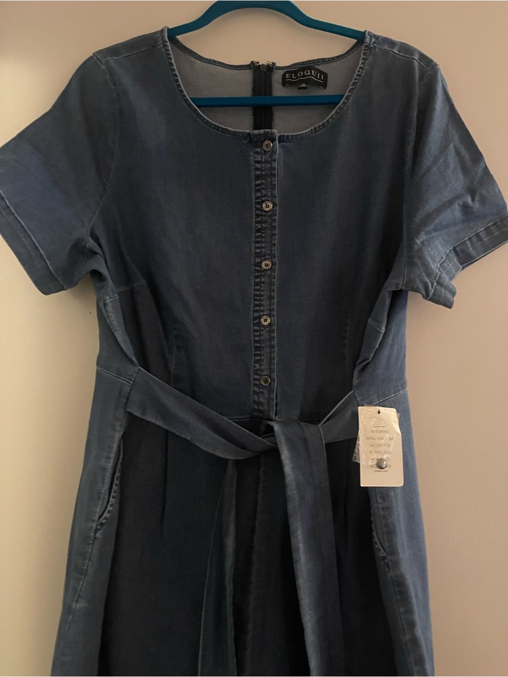 Eloquii denim romper with belt attached.